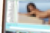 A pixelated pornographic image on a computer screen.