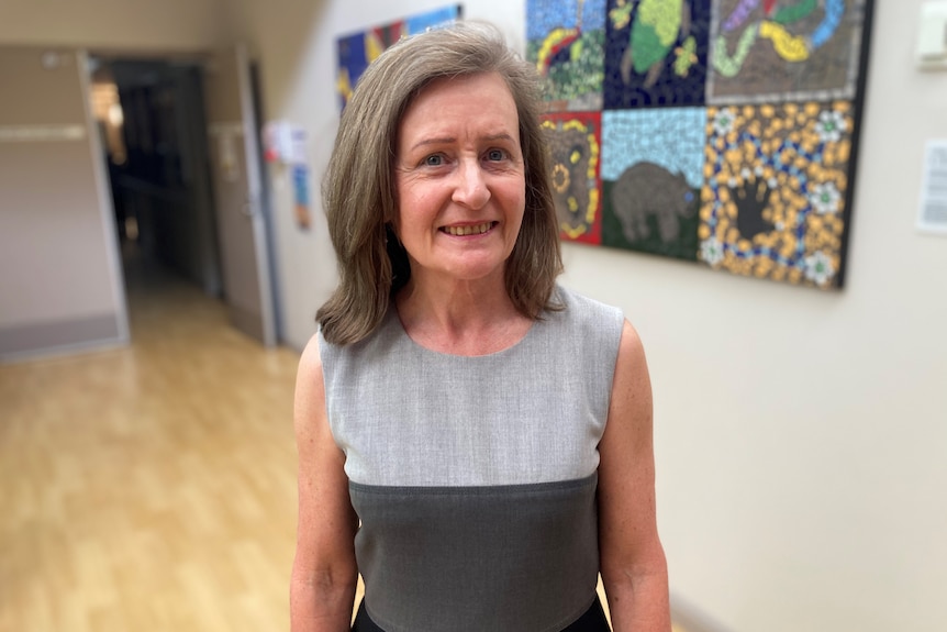 Karitane specialist Dr Karen Raine standing in a well-lit room with art on the walls.