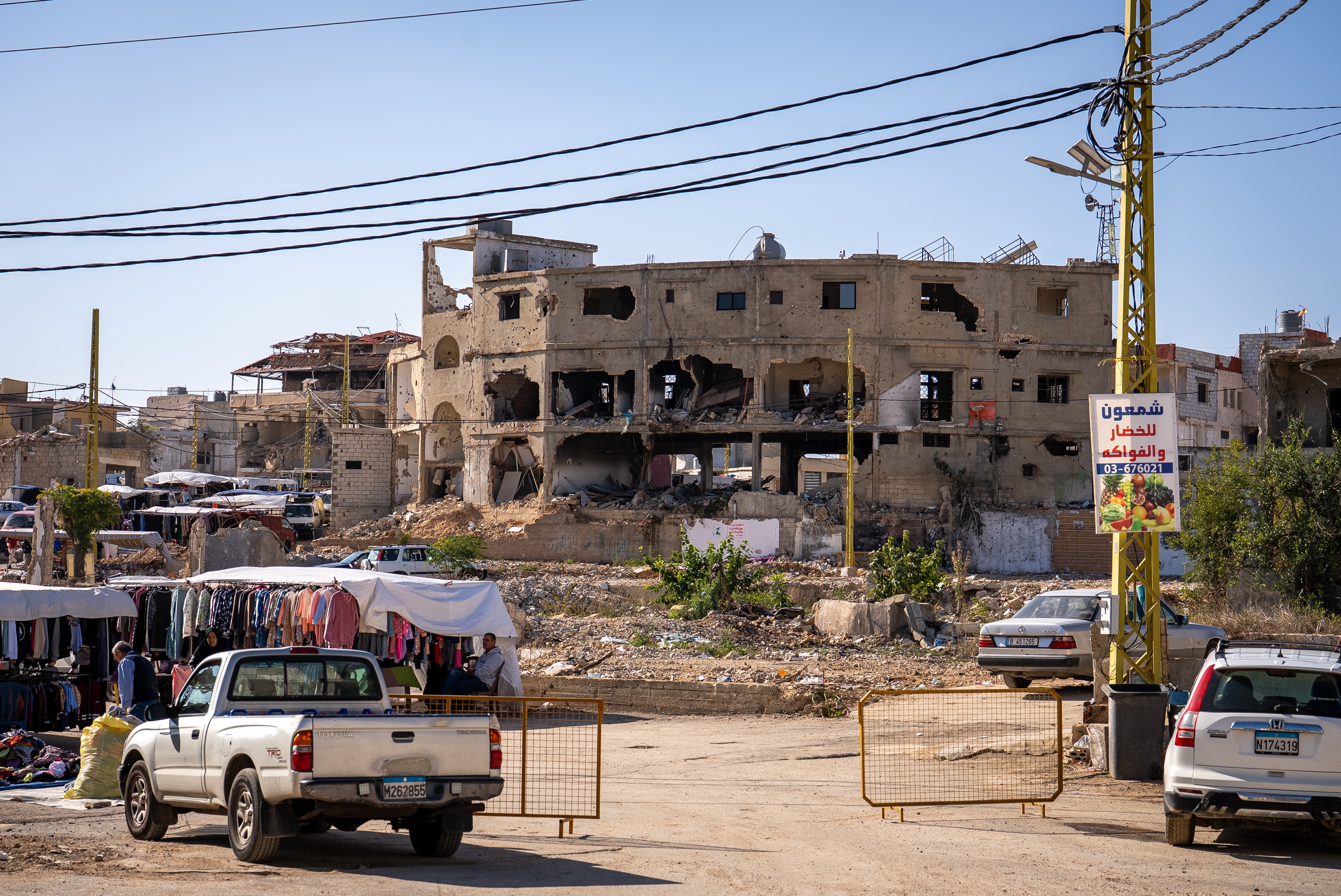 Damaged building above a street market.