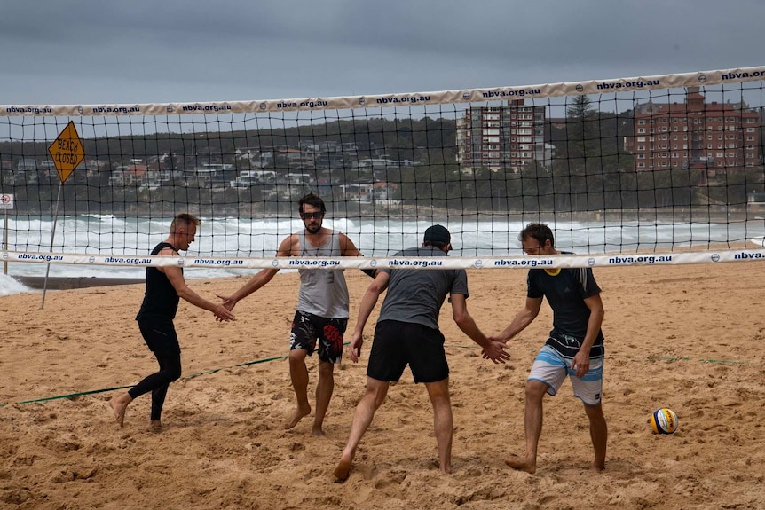 Four men on Manly beach.