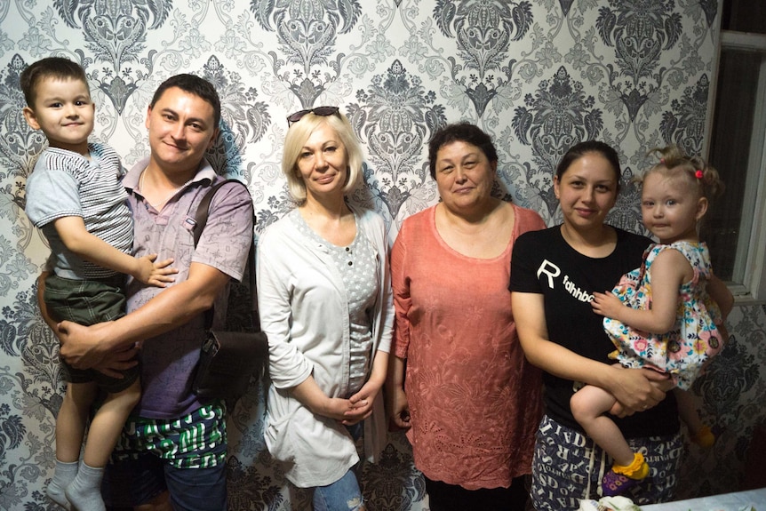 A smiling group of women in their home