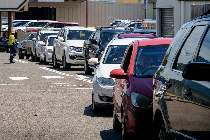 A queue of vehicles lined up at the entrance of the Reef Recycling depot in Townsville.