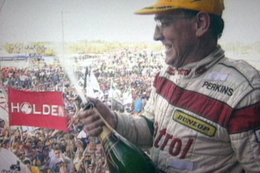 Larry Perkins sprays champagne over the crowd