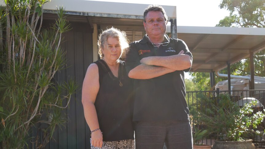 Kimberley man and woman stand in front of house. 