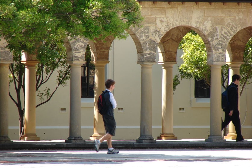 A student walks along a path at the University of Western Australia.