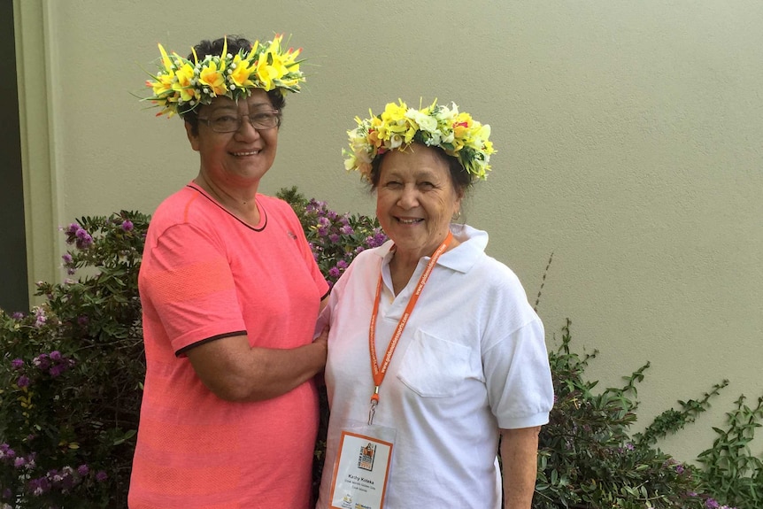 Two women from the Cook Island with plastic flowers in their hair