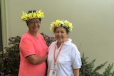 Two women from the Cook Island with plastic flowers in their hair