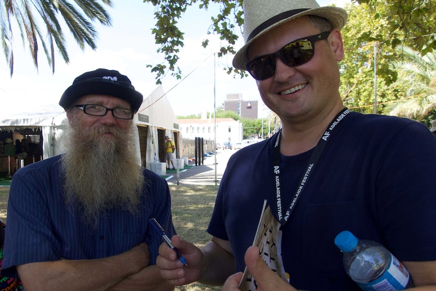 AS Patric signs a copy of his book