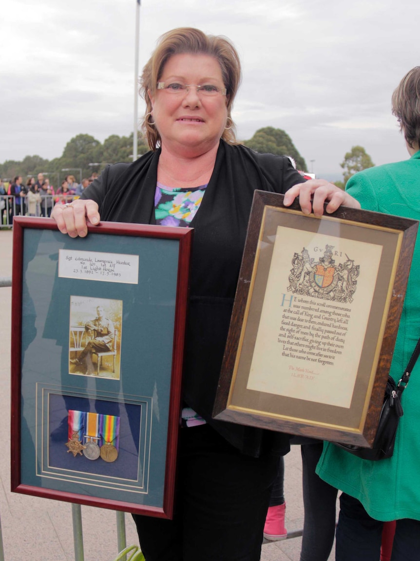Canberran Helen Edmunds showed Prince Harry two plaques of her family history.