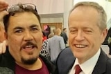 Bill Shorten closes his eyes while smiling for a photo with Wayne Kurnorth.