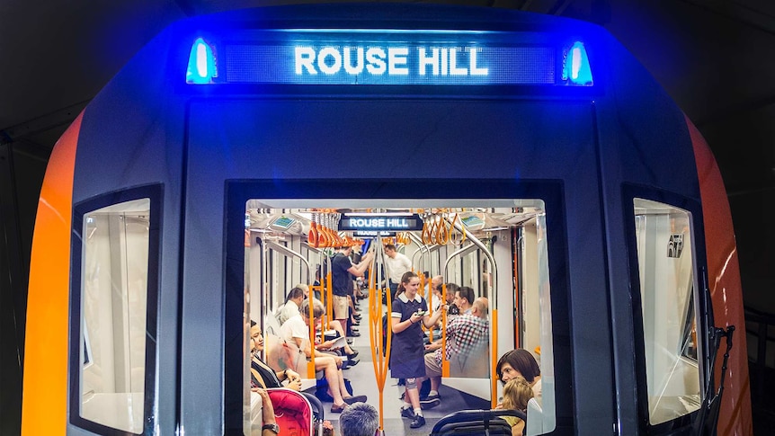 People look out through the front window of a driverless train.