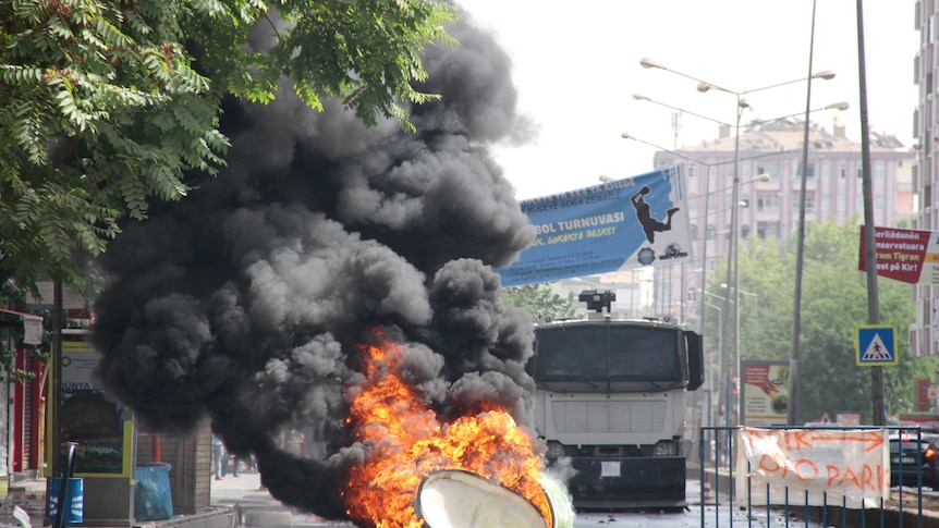 A trash can is set on fire by protesters in Turkey