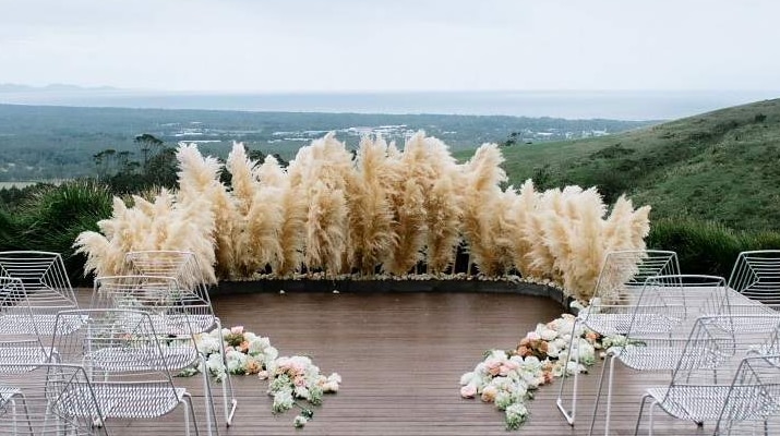 Pampas grass surrounds the wedding altar at an outdoor Byron Bay wedding.