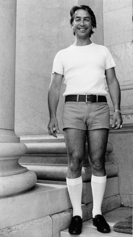 Don Dunstan stands outside Parliament House in his infamous pink shorts.