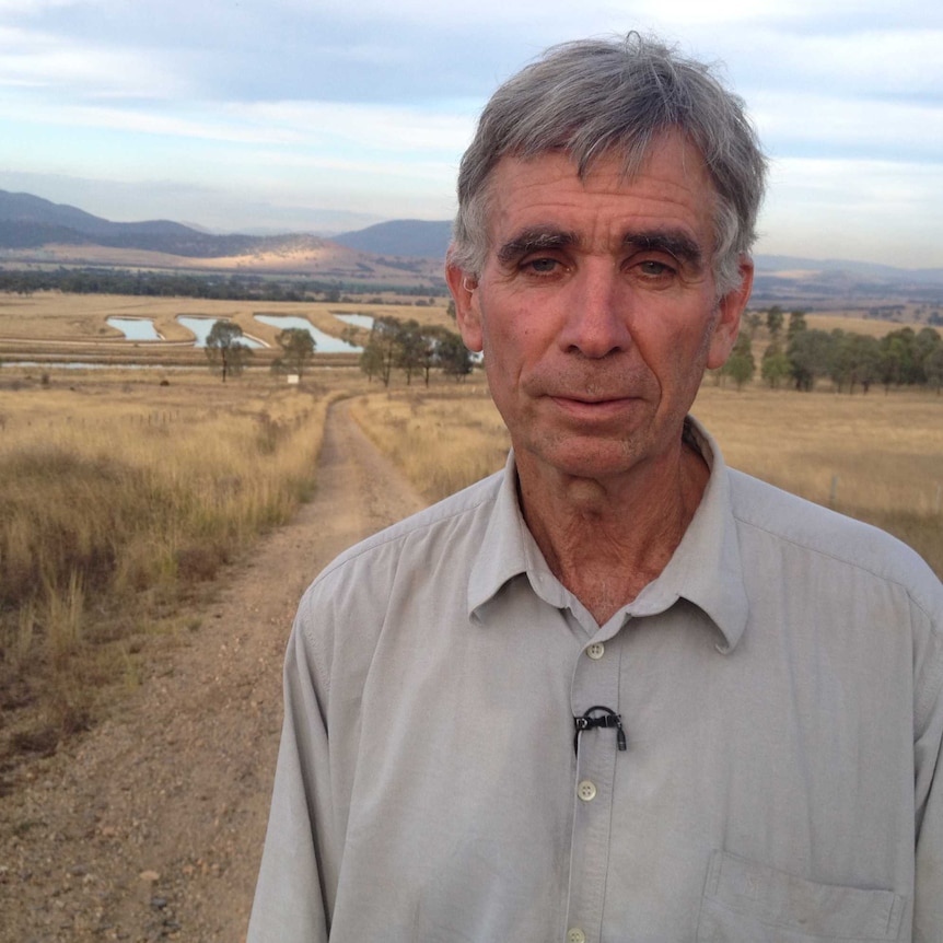 Hunter Valley landowner Tony Lonergan in front of the Dartbrook mine evaporation ponds.