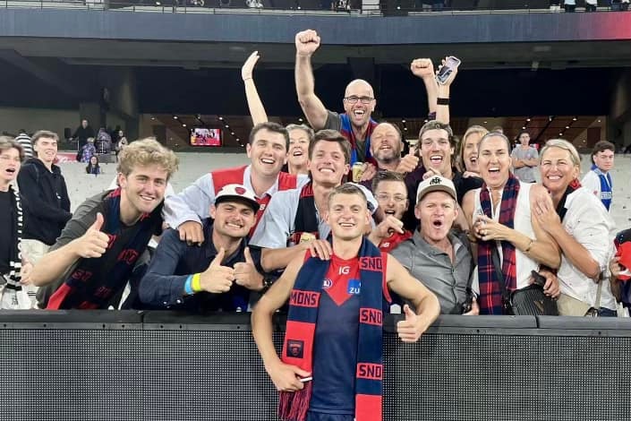 Melbourne demons AFL player after the game with friends and family at a stadium
