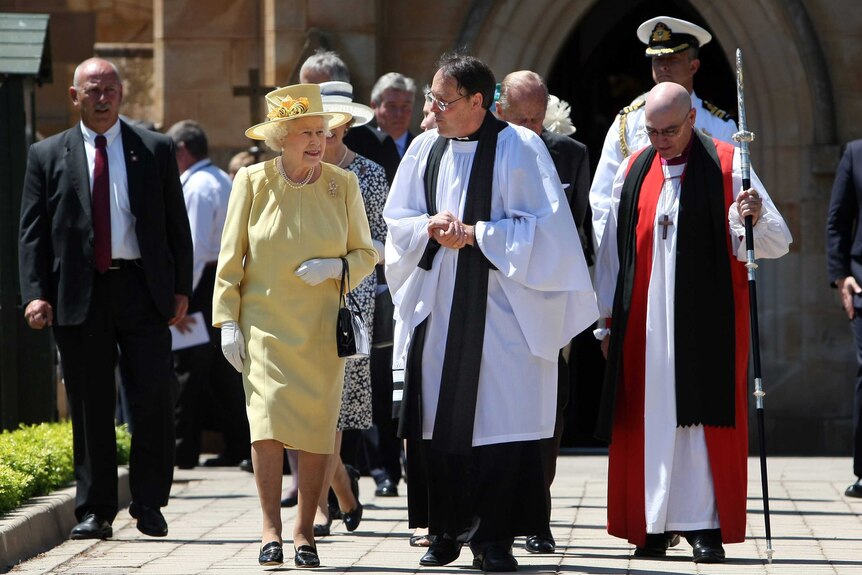 Queen Elizabeth II and Reverend Paul Black talk as they leave a service at St John's Church in Canberra.