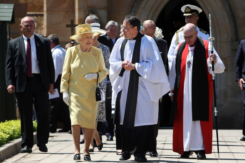 Queen Elizabeth II and Reverend Paul Black talk as they leave a service at St John's Church in Canberra.