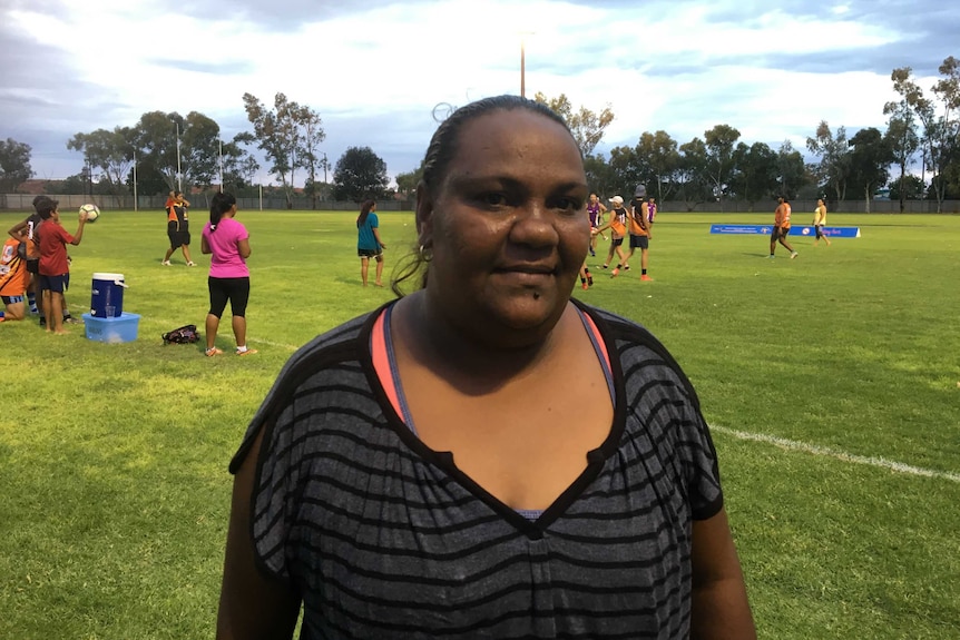 Melissa Rankine stands on a sports field.