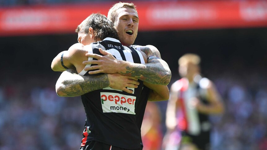 Tim Membrey and Ben Long embrace in a tight hug.