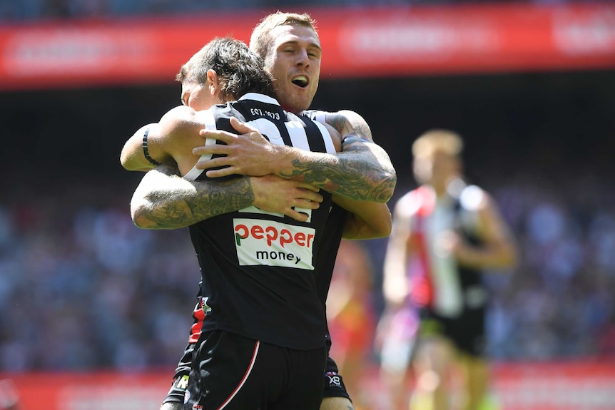 Tim Membrey and Ben Long embrace in a tight hug.