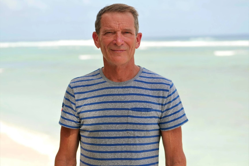 Chair of the Cocos Keeling Island's Tourism Association Michael Kirkpatrick stands by the water on West Island