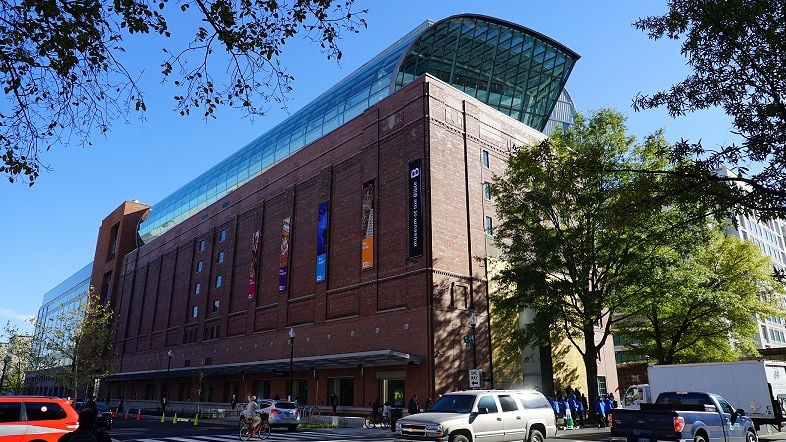 The front of The Museum of the Bible in Washington DC with traffic passing by