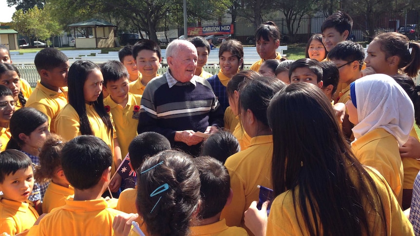 John Donsworth is surrounded by students from Bankstown Public School in Sydney's south-west