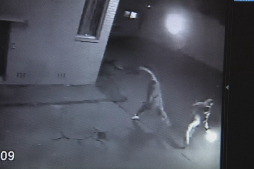 A still of CCTV footage of two men throwing Molotov cocktails at a Rooty Hill tattoo parlour in June, 2015.