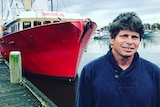 Newcastle fisherman Brett Bollinger standing in front of his fishing trawler