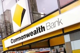 Pedestrians walk past a Commonwealth Bank of Australia branch