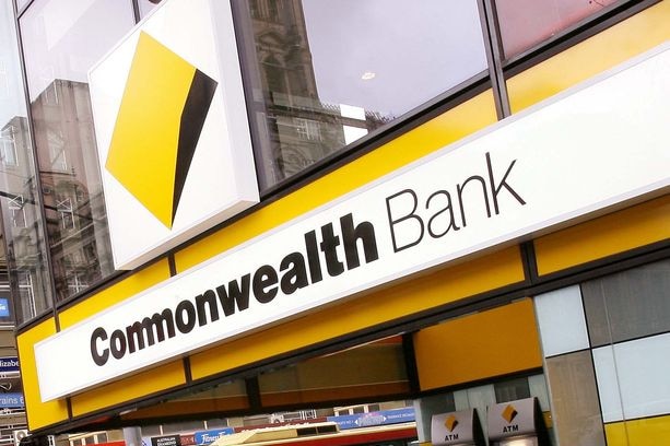 Pedestrians walk past a Commonwealth Bank of Australia branch