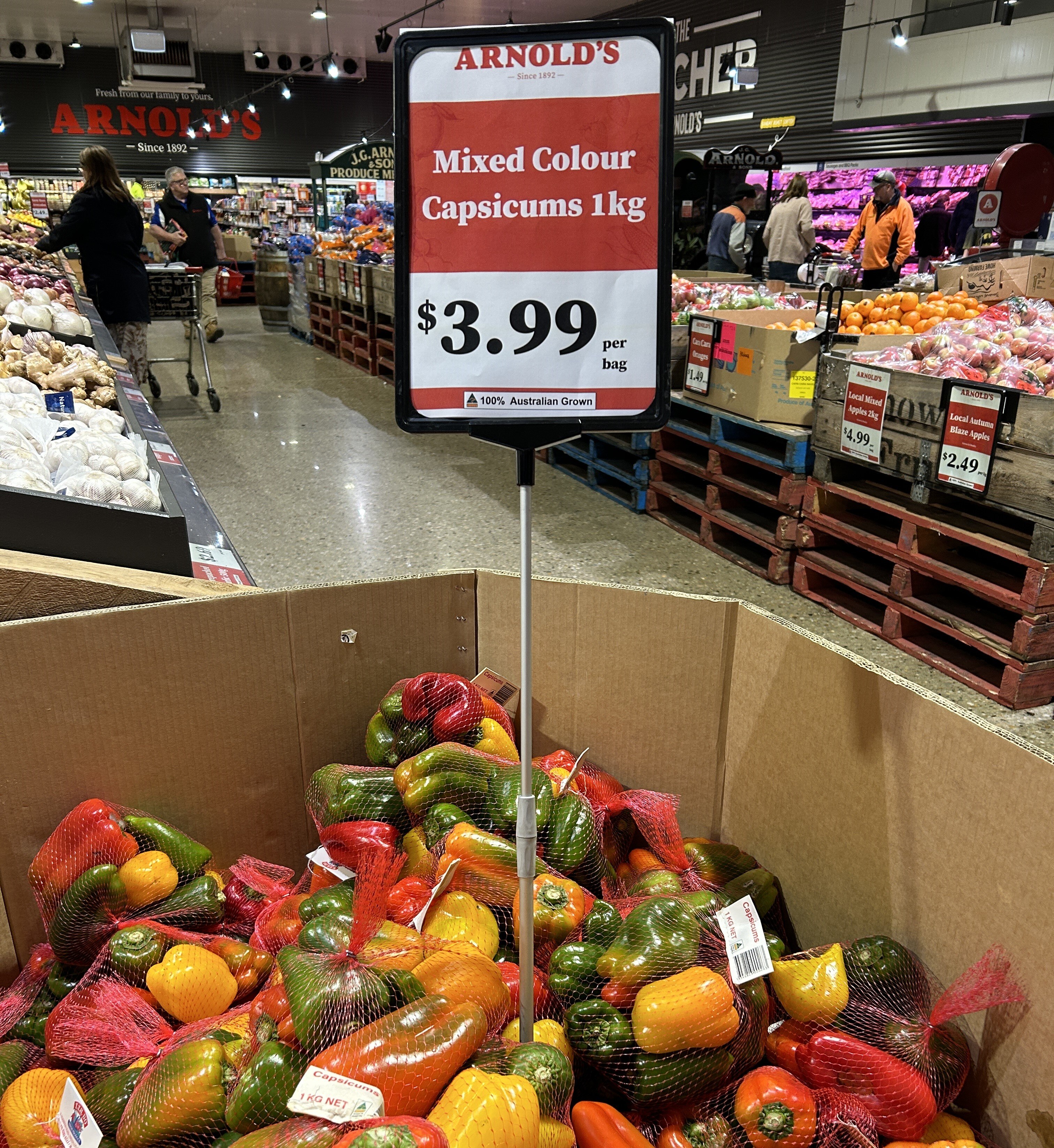 A large box of capsicums on sale at a grocer in Wodonga.