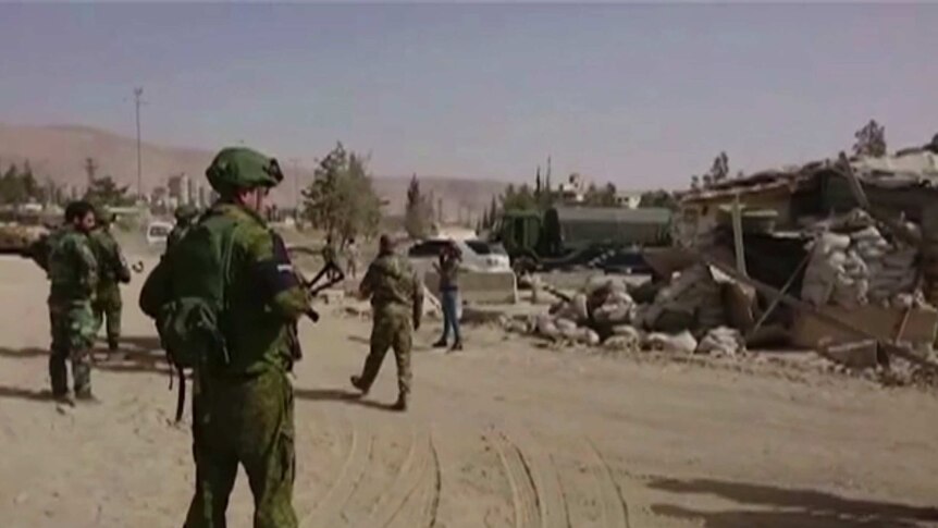 Syrian and Russian forces oversee evacuations in eastern Ghouta. It is a still from a video