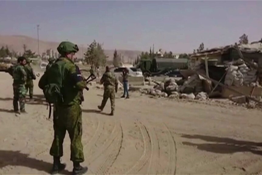 Syrian and Russian forces oversee evacuations in eastern Ghouta. It is a still from a video