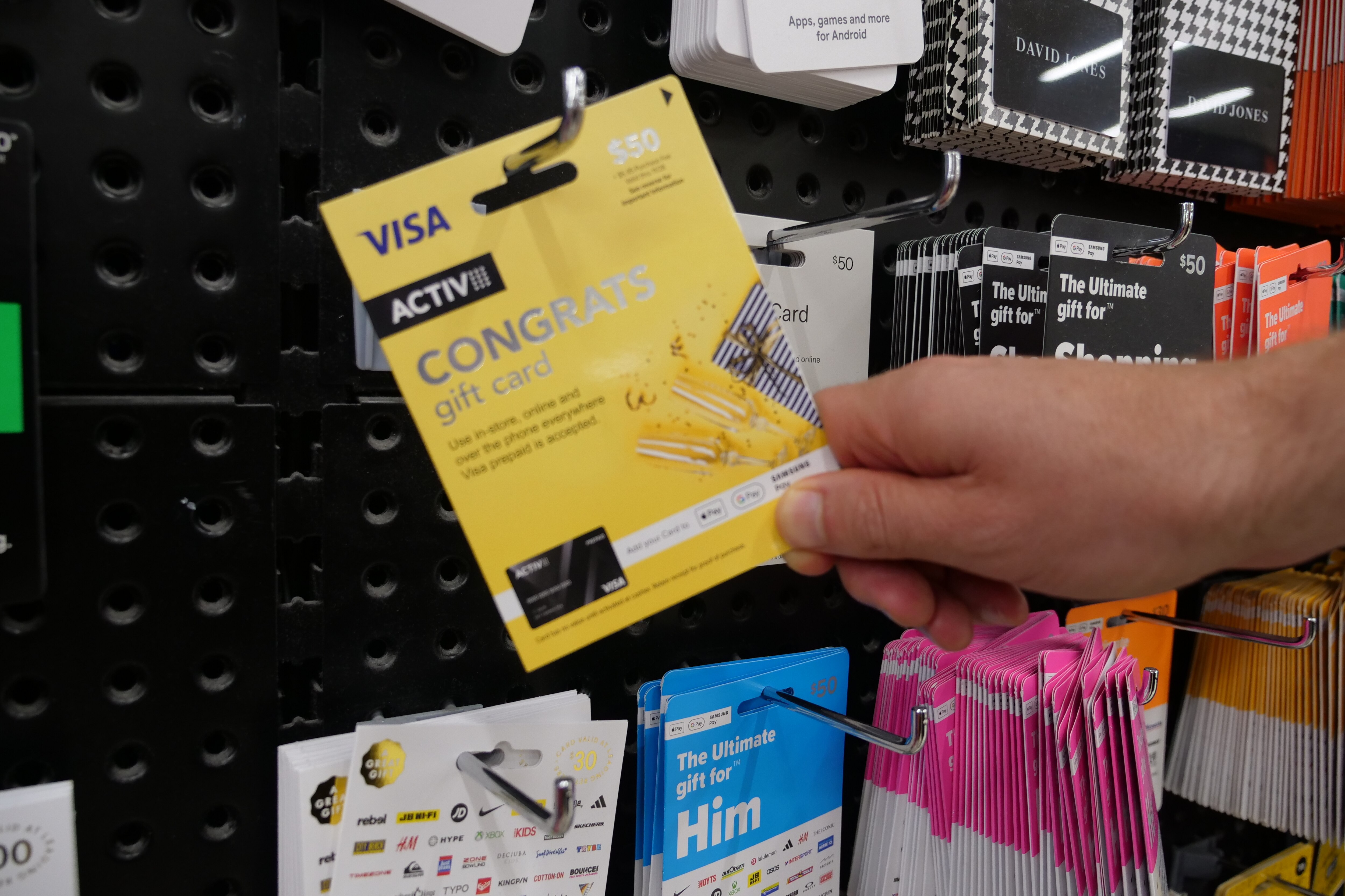 Rows of gift cards on a wall at a supermarket