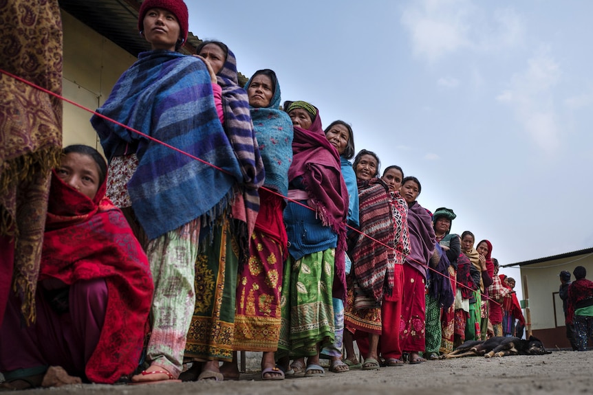 Nepal women queue at Oxfam shelter