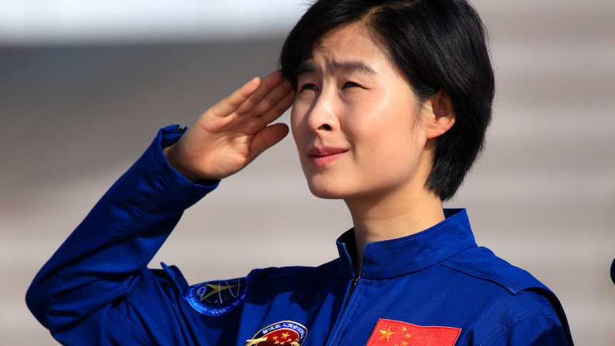 This picture taken on June 10, 2012 shows China's first female astronaut Liu Yang salutes during a ceremony.
