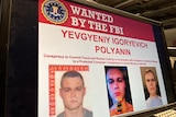 A computer screen showing a wanted poster for Yevgeniy Igreyevich Polyanin