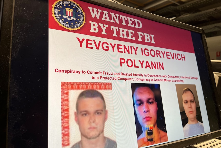 A computer screen showing a wanted poster for Yevgeniy Igreyevich Polyanin
