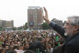 Defeated Iranian presidential candidate Mir Hossein Mousavi waves to protesters during a rally in Te