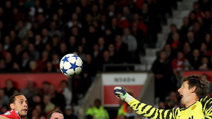 Manchester United goalkeeper Edwin van der Sar punches the ball clear at Old Trafford.