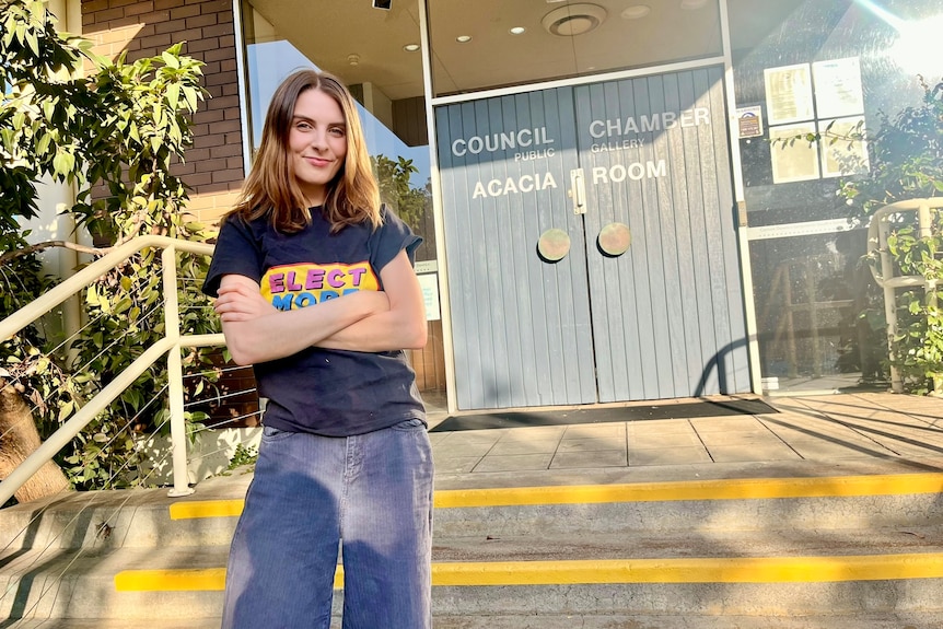 Woman with deep orange bob cut with arms crossed in Frankston street