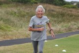 Judy Amoore Pollock runs with a big smile on her face.