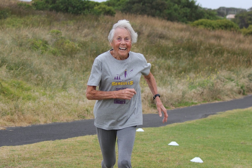 Judy Amoore Pollock runs with a big smile on her face.