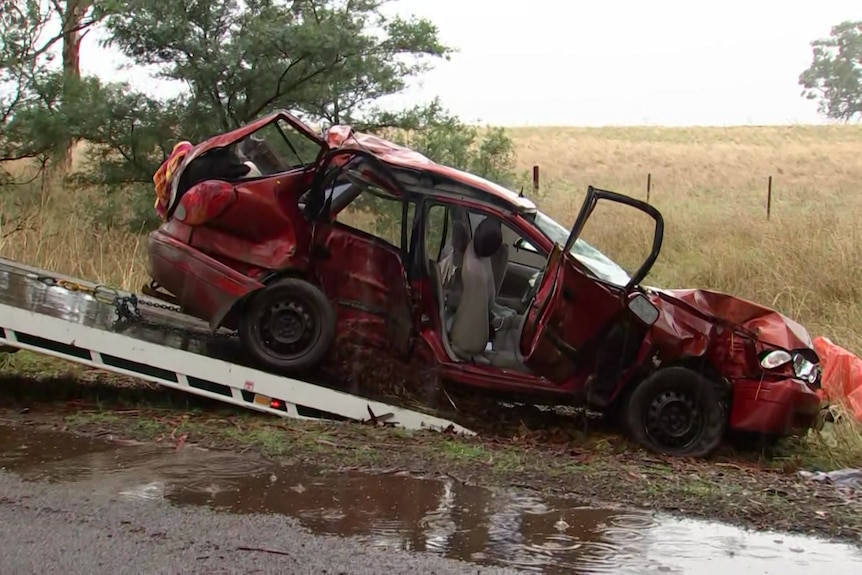 A crashed car being towed.