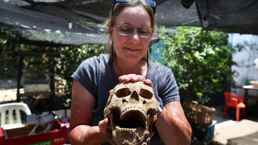 Archeologist holds Philistine skull