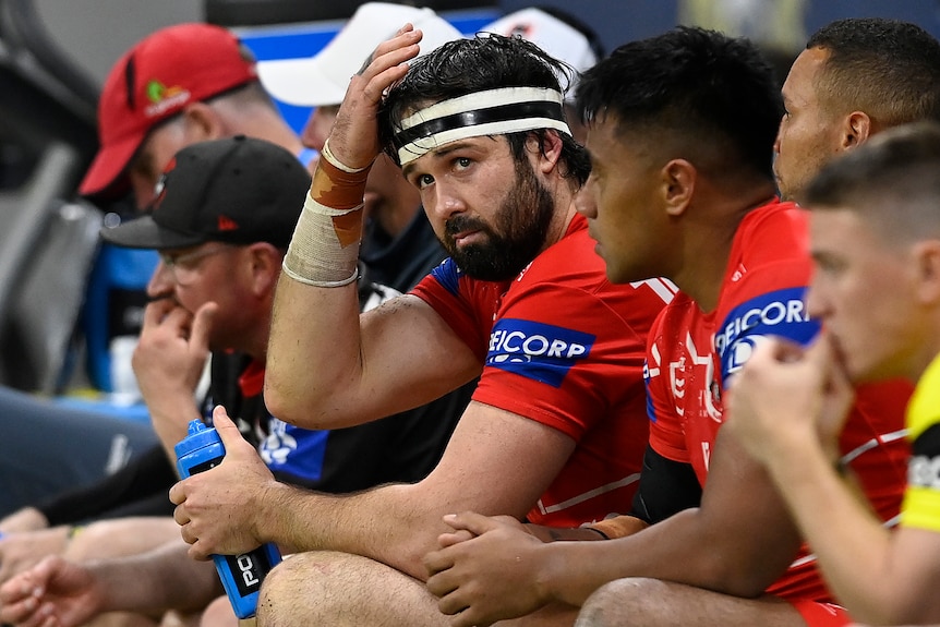 A man looks sad sitting on the bench for a rugby league side 