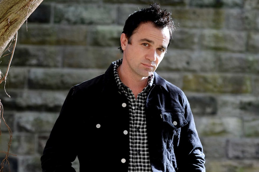 Shannon Noll poses with his hands in his pockets.