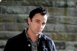Shannon Noll poses with his hands in his pockets.